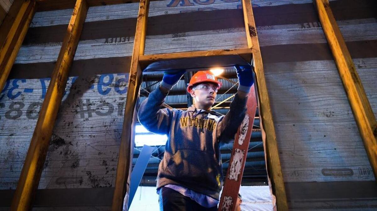 Mendota High’s Riley Lopez uses a level as he and other students learn how to attach sheet metal to a structure, during a job-shadowing day at Four C’s Construction, coordinated by the Fresno County Office of Education’s Career Technical Education program, Thursday morning, Jan. 19, 2017.
