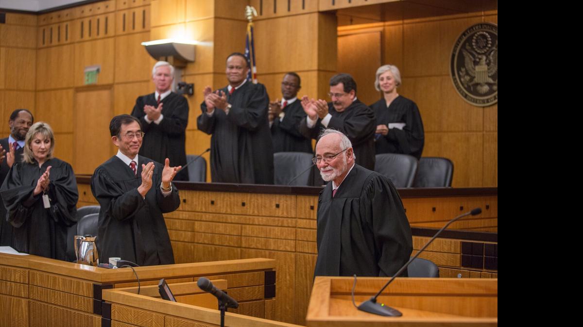 
U.S. District Judge Lawrence K. Karlton receives a standing ovation from friends and colleagues during a celebration of his retirement in September.

