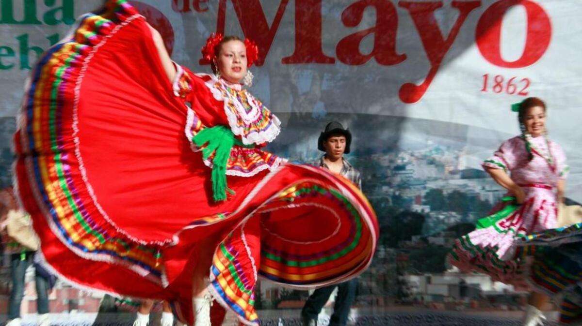 Marylin Castillo dances in Los Angeles on May 5, 2011, in honor of the Cinco de Mayo celebration. Half of Angelenos either are Latin American immigrants or their descendants, but today, 60 percent of Latinos in Los Angeles County are native born. (AP Photo/ Nick Ut)