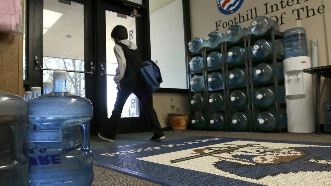 Water bottles line the entrance to Foothill Intermediate School in Loma Rica, Calif., in 2016. Lead in the school’s drinking water frequently rises to unhealthy levels, forcing district officials to haul in bottled water until they find the source of the contamination and eliminate it. Unsafe drinking water is an ongoing problem in much of California, with children and the elderly at greatest risk. (AP Photo/Rich Pedroncelli)