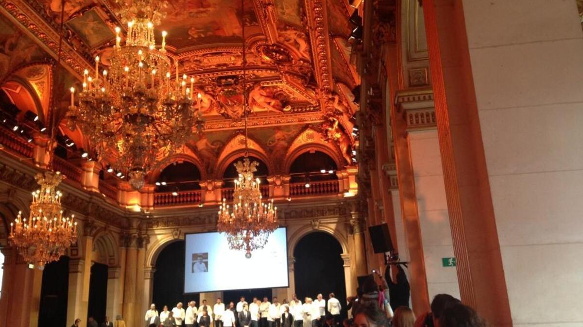 With white-clad chefs ranged behind her, Paris Mayor Anne Hidalgo honors 84 Michelin-starred chefs and declares that the terrorist attacks were attacks on France’s way of life.