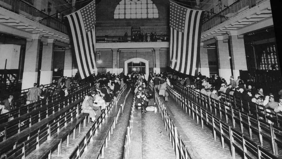 Immigrants wait in the registry room at Ellis Island in New York harbor in this 1924 photograph.