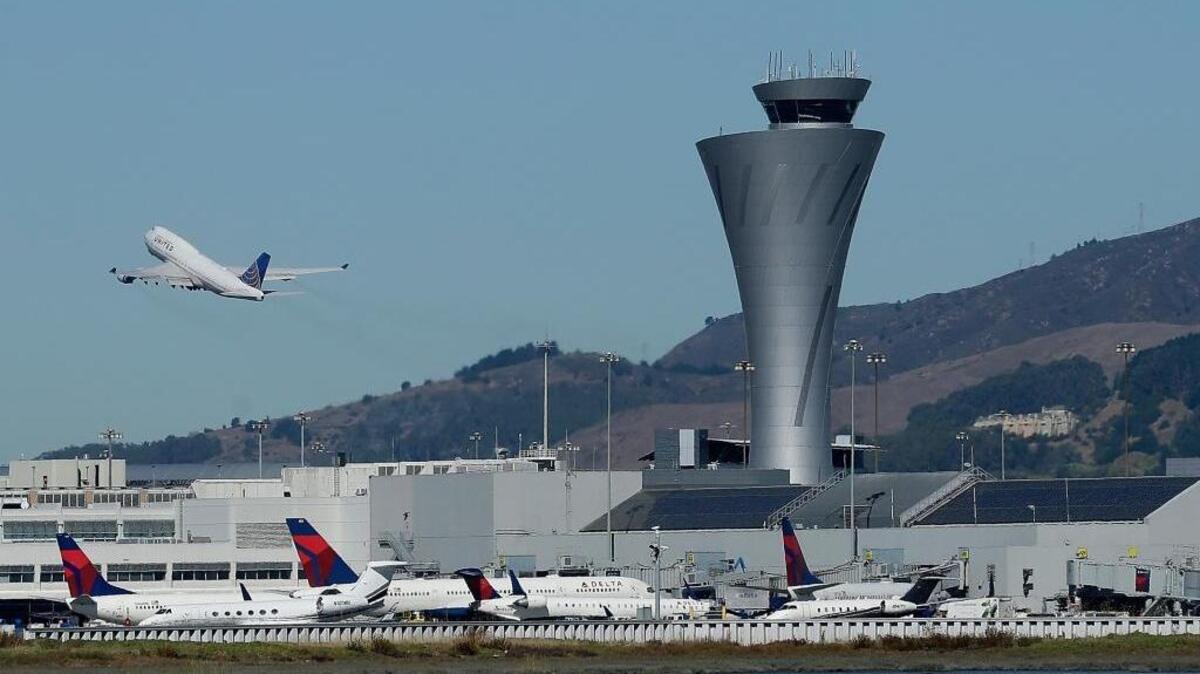 The air traffic control tower is in sight as a plane takes off from San Francisco International Airport, Tuesday, Oct. 24, 2017, in San Francisco. A bill in Congress would effectively privatize air traffic control, handing operations over to a nonprofit critics say would be dominated to the detriment of taxpayers and consumers by commercial airlines.