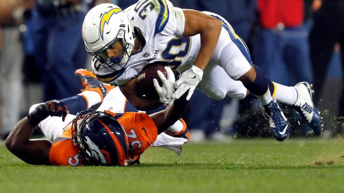 Denver Broncos inside linebacker Corey Nelson (52) tackles Los Angeles Chargers running back Austin Ekeler (30) during the second half of an NFL football game, Monday, Sept. 11, 2017, in Denver. (AP Photo/David Zalubowski)
