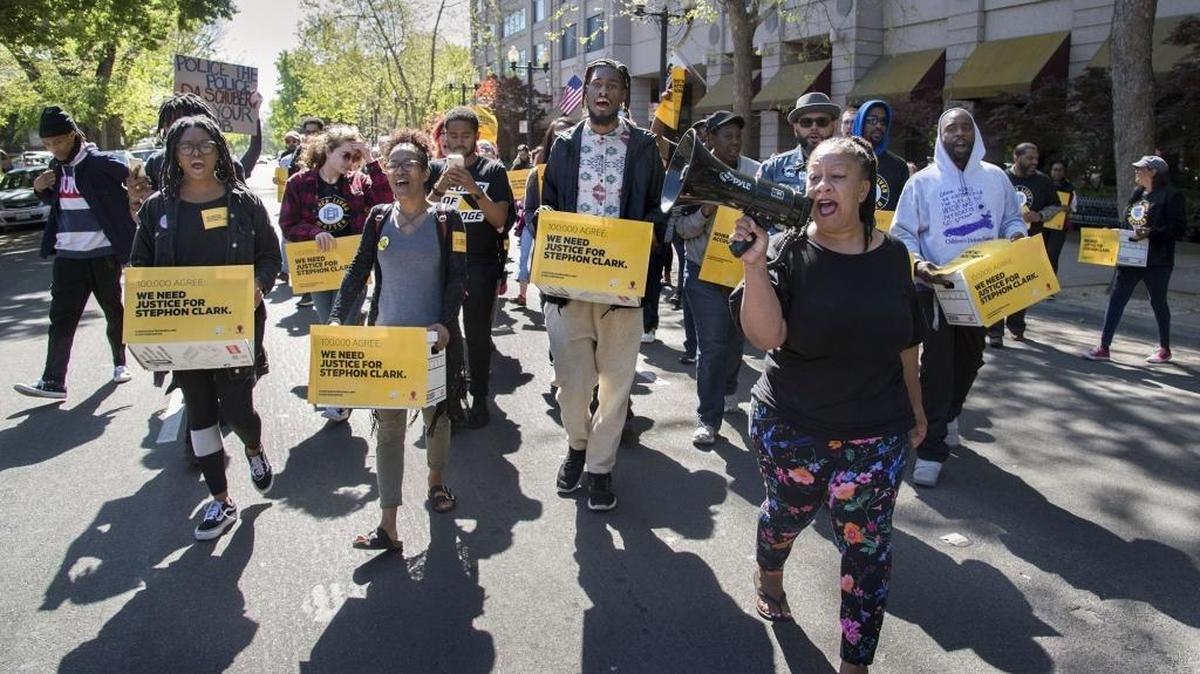 Protesters led by Tanya Faison of Black Lives Matter march from the state Attorney General's office at 13th and I streets to Sacramento District Attorney Anne Marie Schubert's office at 9th and G streets where they delivered nine boxes of 100,000 signatures from an online petition asking District Attorney Anne Marie Schubert to file charges against the two officers who shot Stephon Clark on Thursday, April 19, 2018 in Sacramento, Calif.
