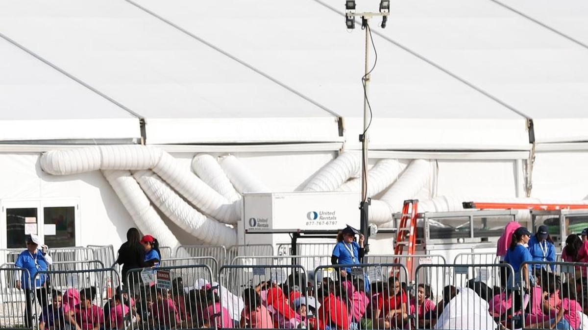 Immigrant children are shown outside a former Job Corps site that now houses them, Monday, June 18, 2018, in Homestead, Fla. (AP Photo/Wilfredo Lee)
