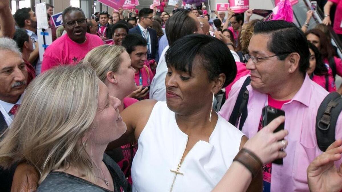 Kimberly Ellis, center, lost to Eric Bauman in last month’s election to head the California Democratic Party. Her team has disputed the result.