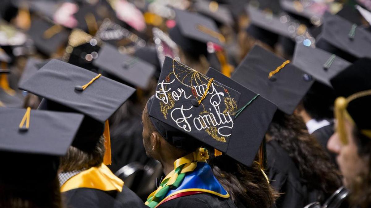 Students from California State University, Sacramento, wait to receive diplomas at their graduation ceremony in 2012.