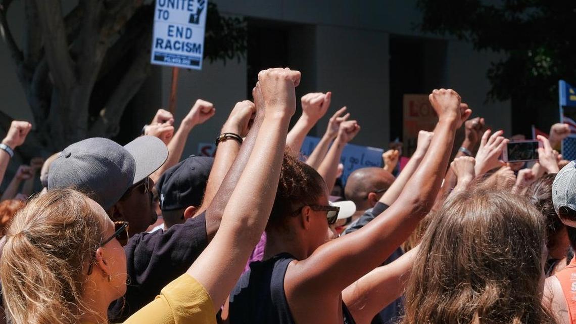 Demonstrators raise clenched fists in defiance to racism during a protest in the Venice Beach area of Los Angeles on Saturday, Aug. 19, 2017. Rallies across California to condemned racism in the wake of the deadly events in Charlottesville, Va. (AP Photo/Richard Vogel)