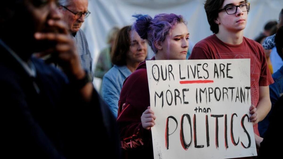A crowd of people hold a rally against gun violence, gathering at Marion Square in downtown Charleston, S.C., Monday, Feb. 19, 2018, following Wednesday's deadly school shooting in Florida.