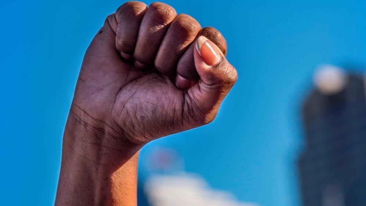 Veronica Curry of Sacramento raises her fist with other Black Lives Matter movement supporters during a rally on Interstate 5 in Sacramento, earlier this year. Another march, by Black Women United, will protest the inequality facing African American women on June 8, 2018, starting at Crocker Park.