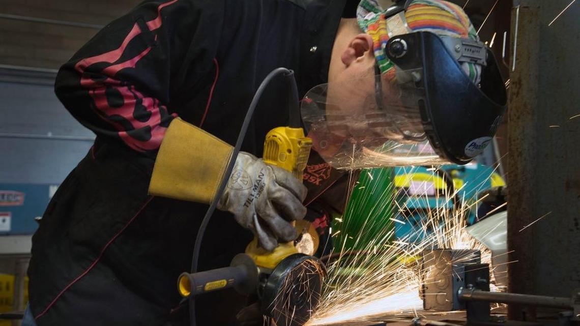 Sam Saeteurn grinds a weld on a test piece in the Welding Technology program at American River College in 2017.