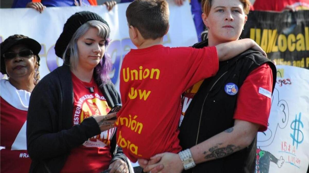 At right, Mackenzie Wilson, 26, is working to shape the minimum wage movement into a larger voting bloc by making alliances with immigration activists and Black Lives Matter, and incorporating child care workers and home health care aides. Wilson, with her partner Kimmie and their 5-year-old son, Damien, attended a rally this month in Sacramento demanding a higher minimum wage.