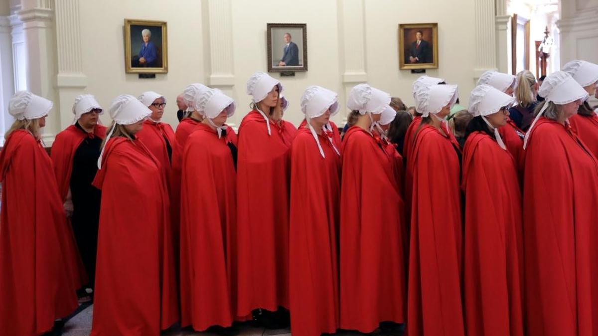 Activists dressed as characters from "The Handmaid's Tale" gather in the Texas Capitol Rotunda as they protest SB 8, a bill that would require health care facilities, including hospitals and abortion clinics, to bury or cremate any fetal remains whether from abortion, miscarriage or stillbirth, and they would be banned from donating aborted fetal tissue to medical researchers, on May 23 in Austin.