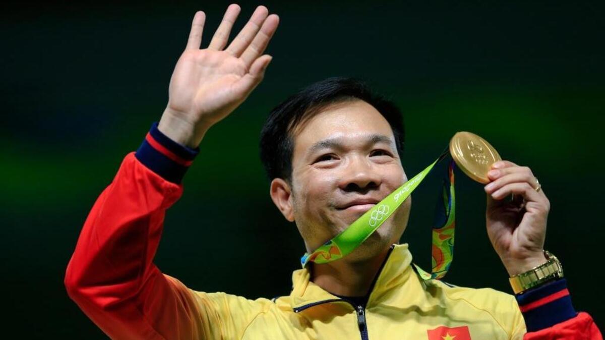 Hoang Xuan Vinh of Vietnam displays his gold medal after the victory ceremony for the men’s 10-meter air pistol event at the 2016 Summer Olympics in Rio de Janeiro on Aug. 6.