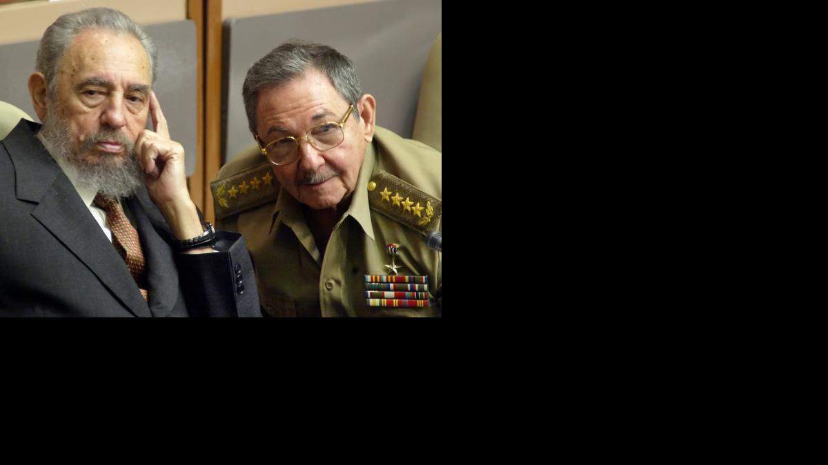 
In this July 31, 2004, photo, Cuba’s President Fidel Castro, left, and his brother, then-Minister of Defense Raul Castro, attend a parliament session in Havana. 
