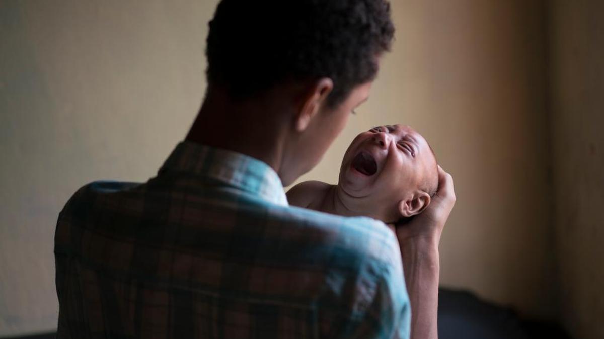 Elielson Wesley tries to calm his baby brother Jose in Bonito, Brazil. Jose struggles to feed, a common trait in children with microcephaly, which can be caused by the Zika virus.