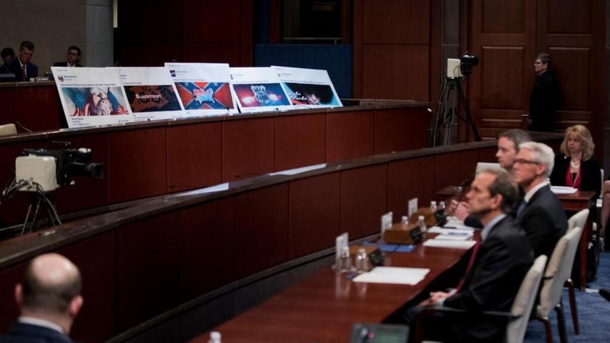 Facebook ads linked to a Russian effort to disrupt the American political process are displayed as, from left, Google’s Senior Vice President and General Counsel Kent Walker, Facebook’s General Counsel Colin Stretch, and Twitter’s Acting General Counsel Sean Edgett testify during a House Intelligence Committee hearing on Capitol Hill in Washington on Nov. 1.