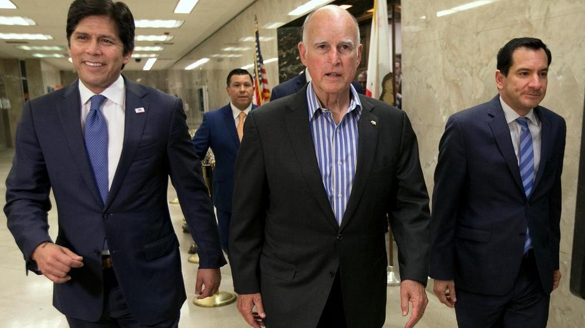 State Senate President Pro Tem Kevin de León, D-Los Angeles, from left, Gov. Jerry Brown and Assembly Speaker Anthony Rendon, D-Paramount, walk through the Capitol to a news conference to discuss the passage of climate change bills on Monday, July 17, 2017. The measures extend the state's cap-and-trade program and aim to improve local air quality. (AP Photo/Rich Pedroncelli)