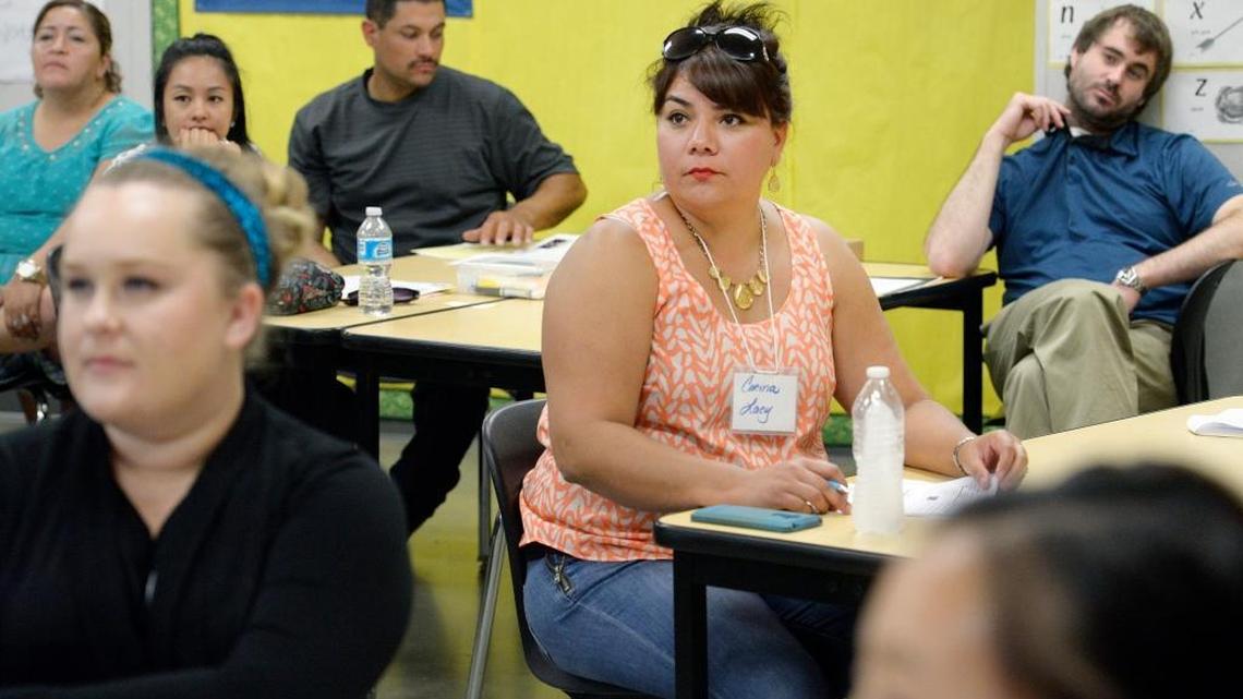 Corina Lacy, center, sits among other new teachers as they receive training during a weekend program for Fresno Unified School District teachers at McLane High School on Sunday, August 7, 2016. CRAIG KOHLRUSS/THE FRESNO BEE