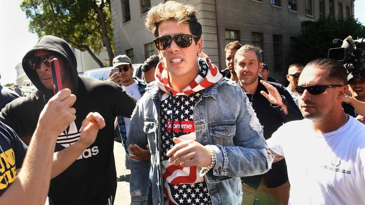 British commentator Milo Yiannopoulos is escorted from Sproul Plaza at the UC Berkeley campus after a speach Sunday, Sept. 24, 2017.