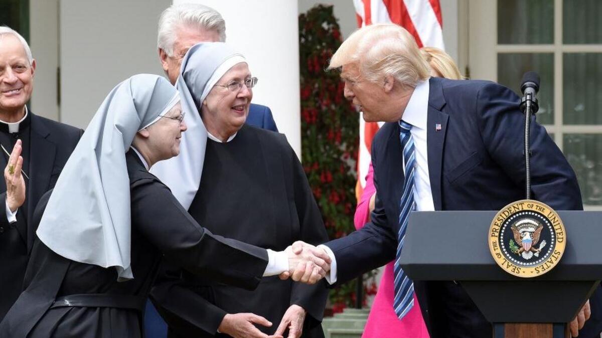 President Donald Trump greets the Little Sisters of the Poor before signing an executive order on religious liberty during a National Day of Prayer Event on Thursday, May 4, 2017 in the Rose Garden of the White House.