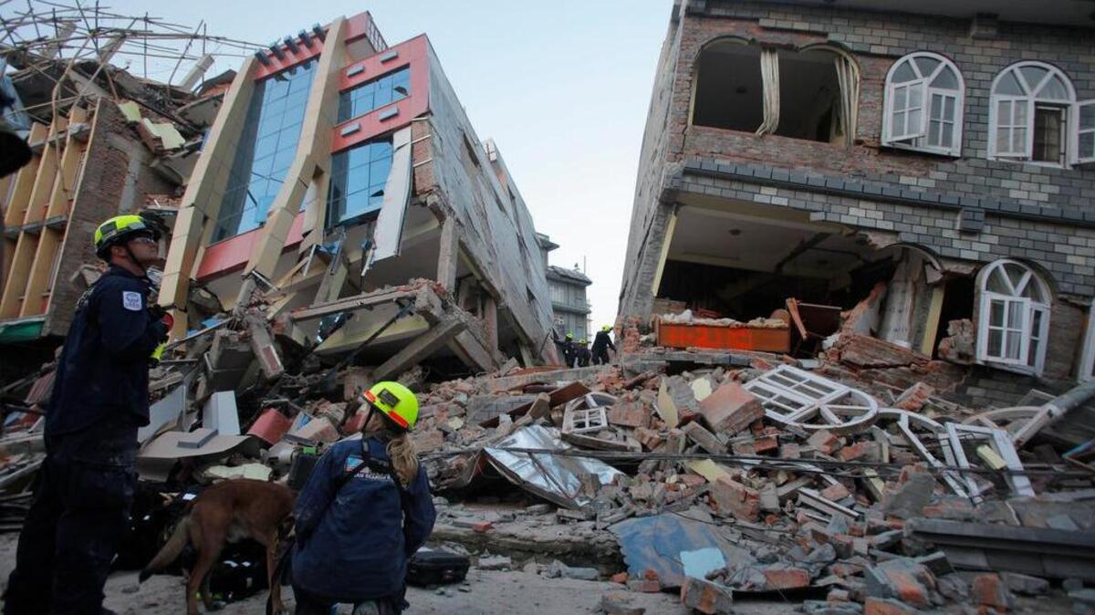 
Rescue workers from the U.S. Agency for International Development in May inspect a building destroyed by an earthquake the previous month in Kathmandu, Nepal.
