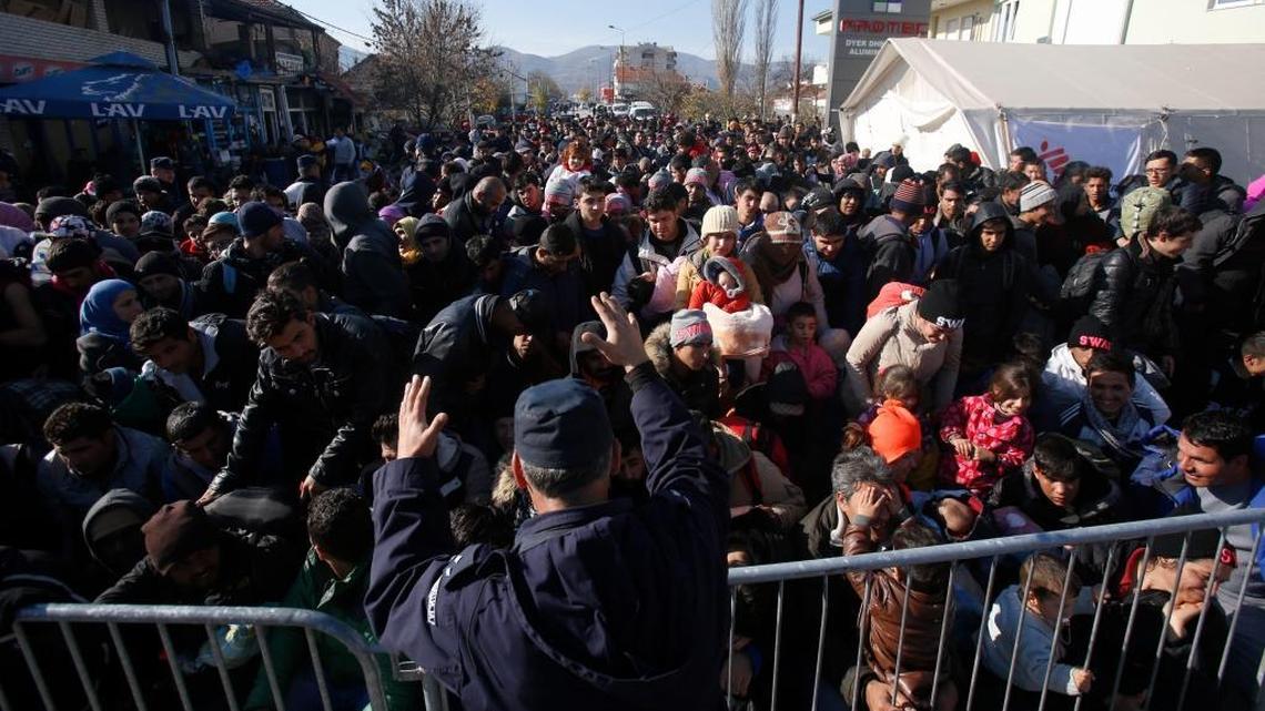 A police officer organizes a throng queuing to get registered at a refugee center in the southern Serbian town of Presevo. Middle East refugees should be invited to join a new military force and given the training, resources and support needed to defeat Islamic State and liberate their homelands.