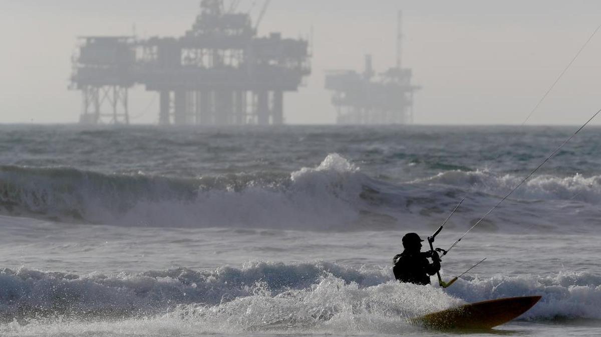 Offshore oil drilling platforms sit along the California coastline off Huntington Beach in January.