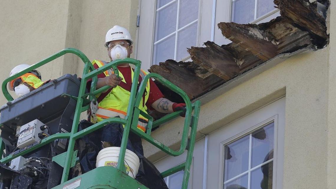 A crew works on the remaining wood of a Berkeley apartment building balcony that collapsed in June 2015, killing six college students and injuring seven others.