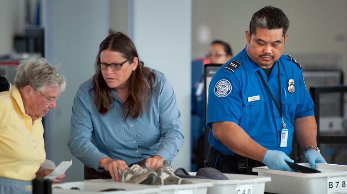 Passengers at Sacramento International Airport load their items into bins before they are sent through the X-ray machine. TSA agents have begun inspecting food and reading materials.