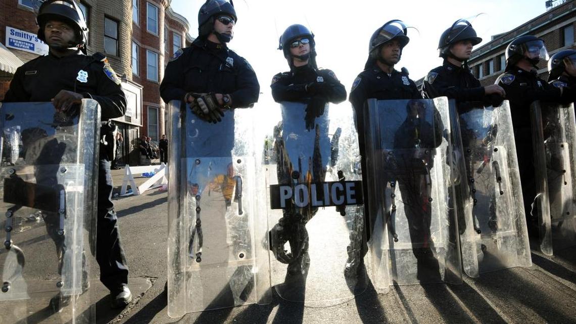 In this file photo, Baltimore Police stand watch after riots sparked by the death of Freddie Gray on April 28, 2016 in Baltimore, Md. The Department of Justice on Aug. 10, 2016 released a report saying Baltimore police routinely violated constitutional rights of residents. (Algerina Perna/Baltimore Sun/TNS)