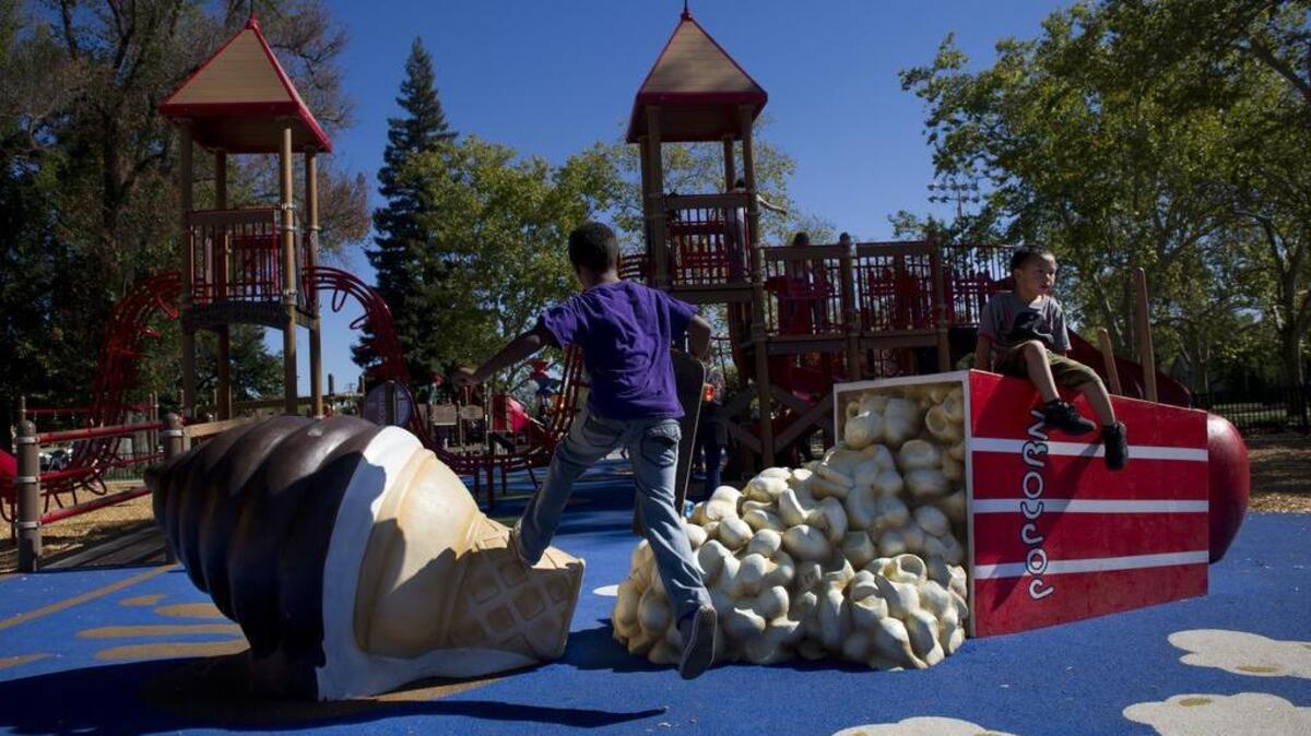 Kids play on oversized food playground equipment at James McClatchy Park in Sacramento’s Oak Park neighborhood in October 2014 during a reopening celebration after a $2.8 million renovation.
