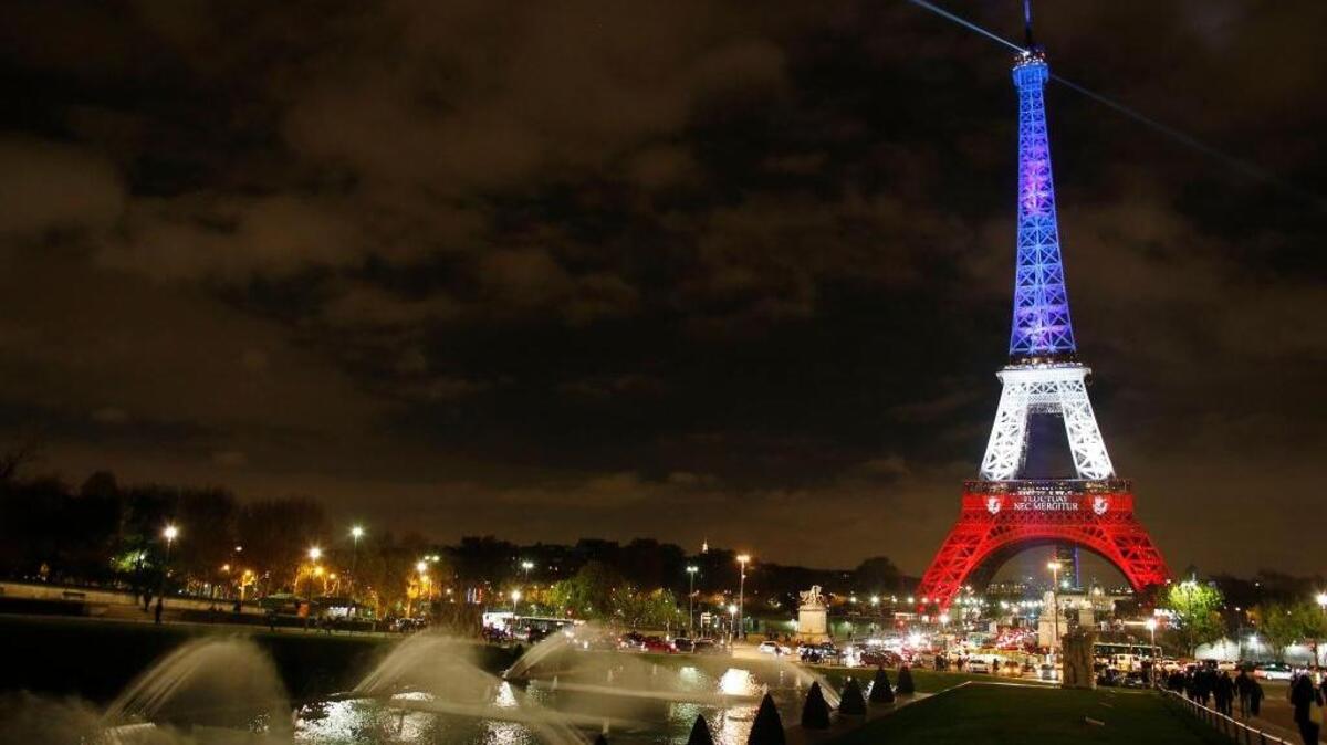The illuminated Eiffel Tower shines in the bright colors of the French national flag in Paris days after the terrorist attacks that killed 130 people on Nov. 13.