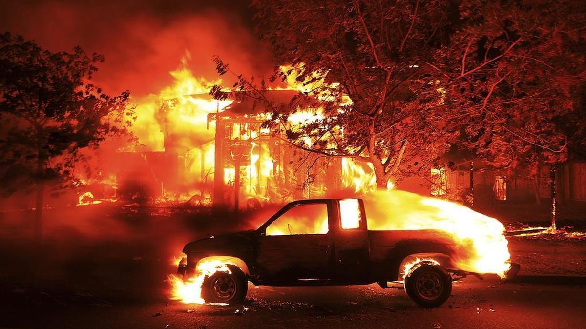 Homes burn in Santa Rosa last October. PG&E said Thursday it expects claims from the wine country fires to top $2.5 billion..