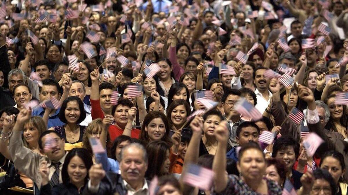 New U.S. citizens take their oaths during a 2008 naturalization ceremony at the Los Angeles Convention Center. (AP Photo/ Damian Dovarganes)