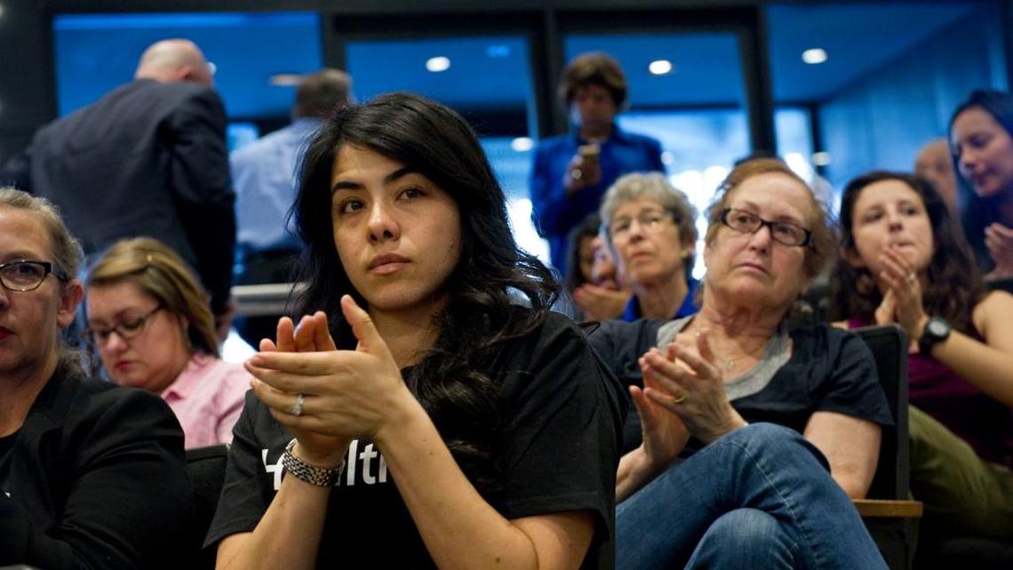 Supporting the California Endowment's #Health4All campaign, Andrea Vega Torres applauds while listening to a speaker during a workshop held by the Sacramento County supervisors to consider options for restoring health care assistance to undocumented immigrants, Wednesday, March 18, 2015.