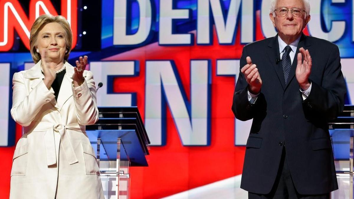 Sen. Bernie Sanders and Hillary Clinton prepare for a debate in New York this month. Sanders has done especially well with younger, white voters, but Clinton has won minority votes decisively.