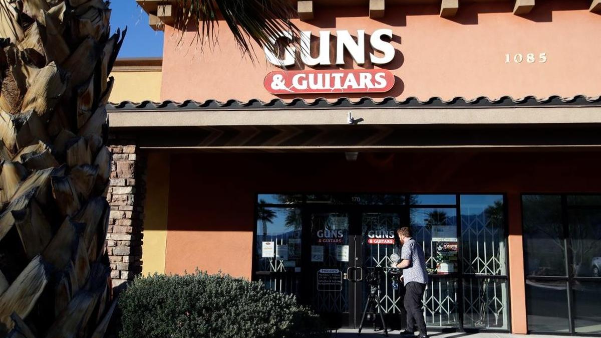 A member of the media takes video footage at the Guns & Guitars store in Mesquite, Nev., Monday, Oct. 2, 2017. The store’s general manager said Stephen Paddock showed no signs of being unfit to buy guns. Paddock killed dozens and injured hundreds last Sunday night when he opened fired at a Las Vegas outdoor country music festival. (AP Photo/Chris Carlson)