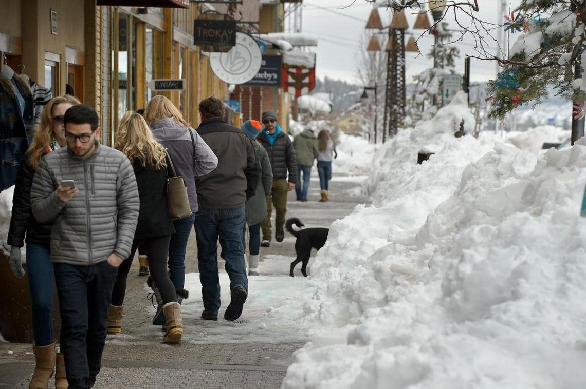 Shoppers file past snowdrifts in 2017 in downtown Truckee.