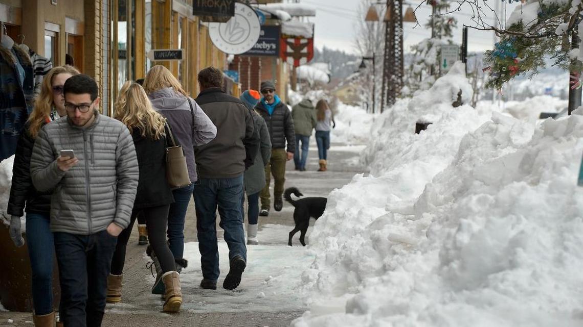 Shoppers file past snowdrifts in 2017 in downtown Truckee. A new infill development is rising in the town’s former railyard.
