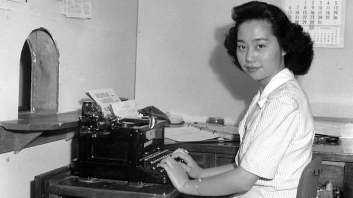 Mitsuye Endo seated at her desk in the administrative office at the Central Utah relocation camp for Japanese Americans during World War II. Endo spent two additional years in the internment camps, deprived of her freedom. Because Endo sacrificed her own liberty to keep her court case alive, the Supreme Court found itself squarely presented with a challenge to the camps in 1944.