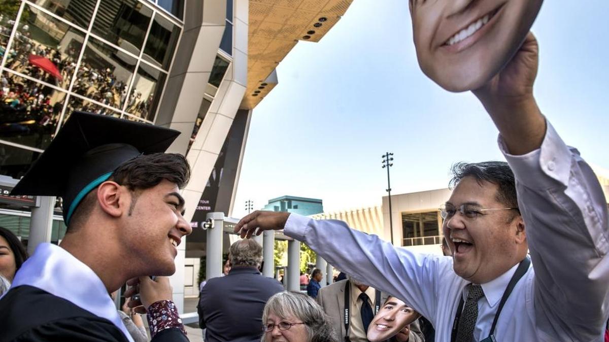 Gene Laoyan, right, celebrates with his son Generoso Vaughn Laoyan, left, after his graduation from Sheldon High School at Golden One Center in Sacramento on Wednesday, May 23, 2018.