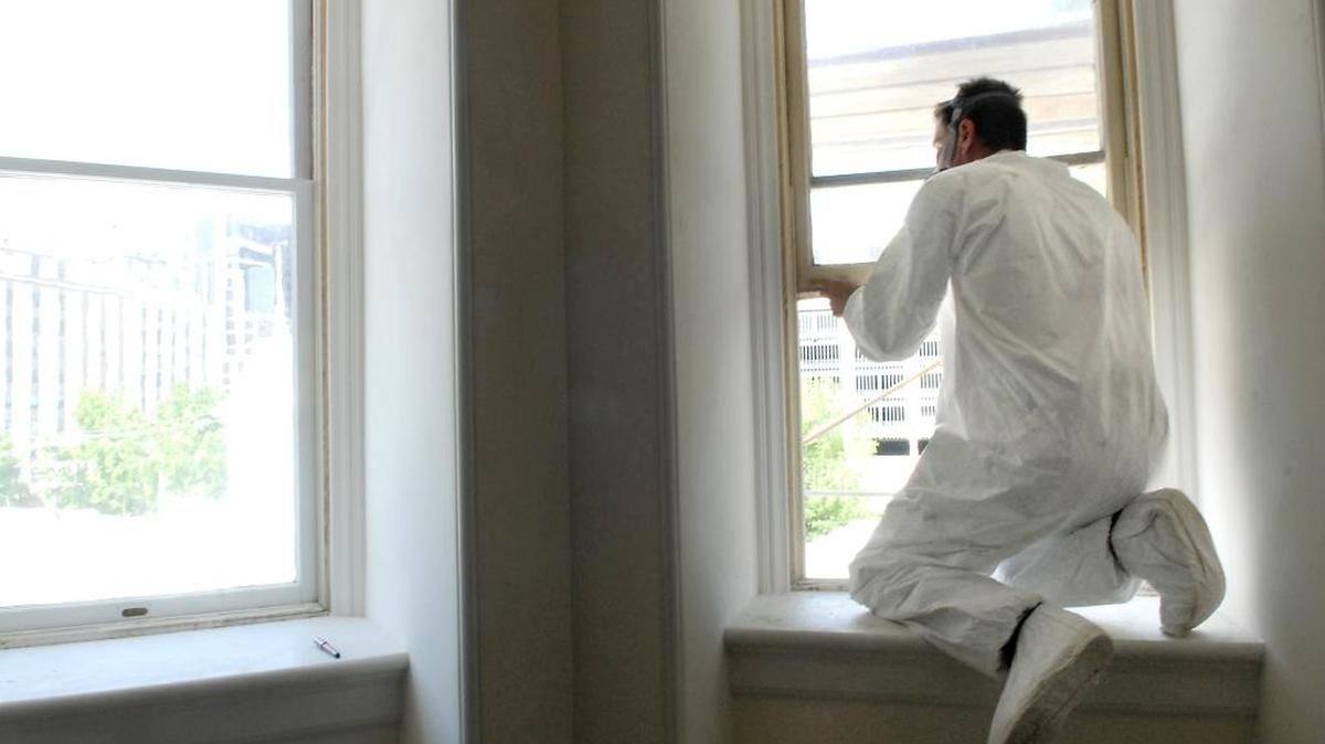 A state parks restoration work specialist strips lead-based paint from the window on the third floor of the Governor’s Mansion in Sacramento, May 23, 2007. Sacramento Bee/ Andy Alfaro