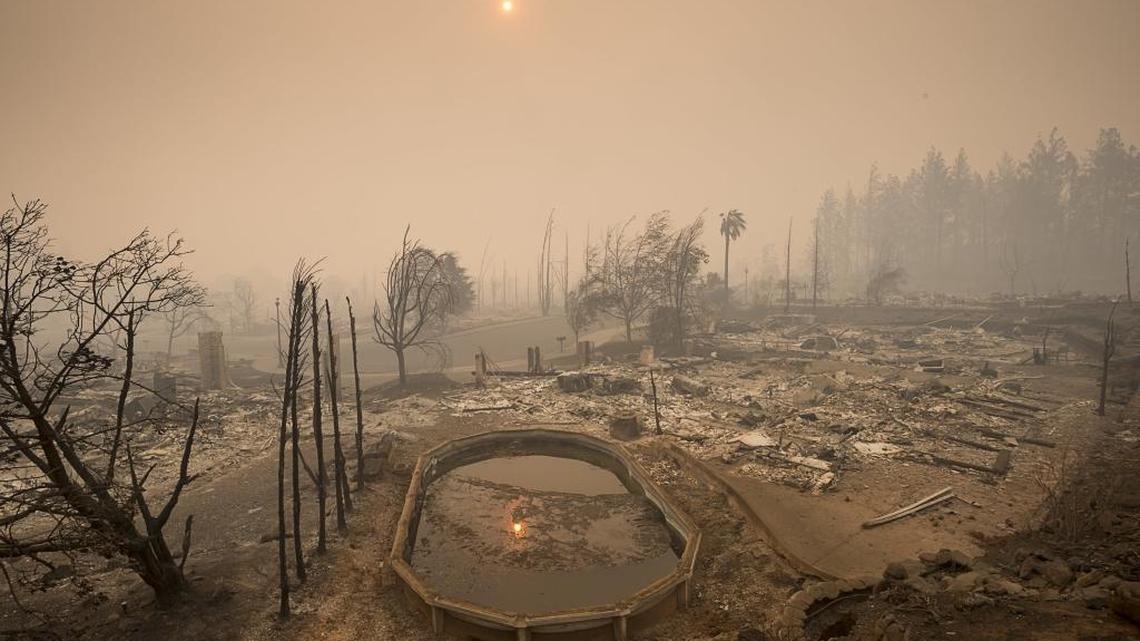 The sun rises through a cloud of smoke in the Rincon Ridge area after a wildfire in Sonoma County on Tuesday October 10, 2017 in Santa Rosa, Calif. 
