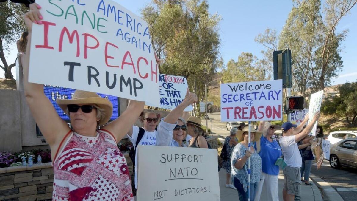 Linda Demyan, left, from Moorpark, joins protestors gathered outside the Ronald Reagan Presidential Library and Center for Public Affairs in Simi Valley as Secretary of State Mike Pompeo delivers remarks on July 22.