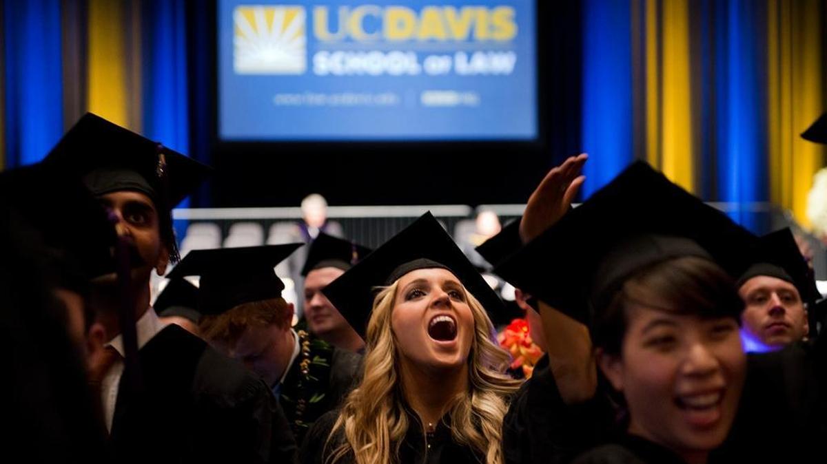 Graduates of the UC Davis law school celebrate after their 2013 commencement. The new Republican tax plan would not only punish states with high education spending, such as California, but also eliminate student loan interest deductions and tax tuition waivers that help many students afford graduate and professional schools.