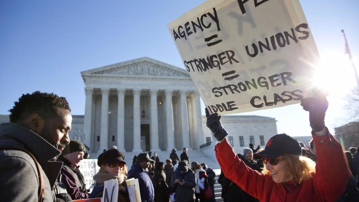 Public employee unions rally outside of the Supreme Court in Washington, Monday, Jan. 11, 2016, to preserve the collection of “fair share” dues from non-members who benefit from collective bargaining. Court conservatives view the practice, which supports organized teachers, firefighters and other public sector employees, as a violation of non-members’ free speech. (AP Photo/Jacquelyn Martin)