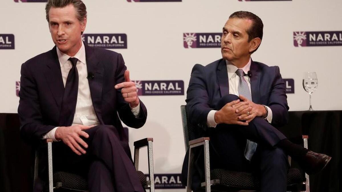 California gubernatorial candidates Gavin Newsom, left, and Antonio Villaraigosa address a pro-choice audience in San Francisco, Tuesday, Jan. 30, 2018. (AP Photo/Jeff Chiu)