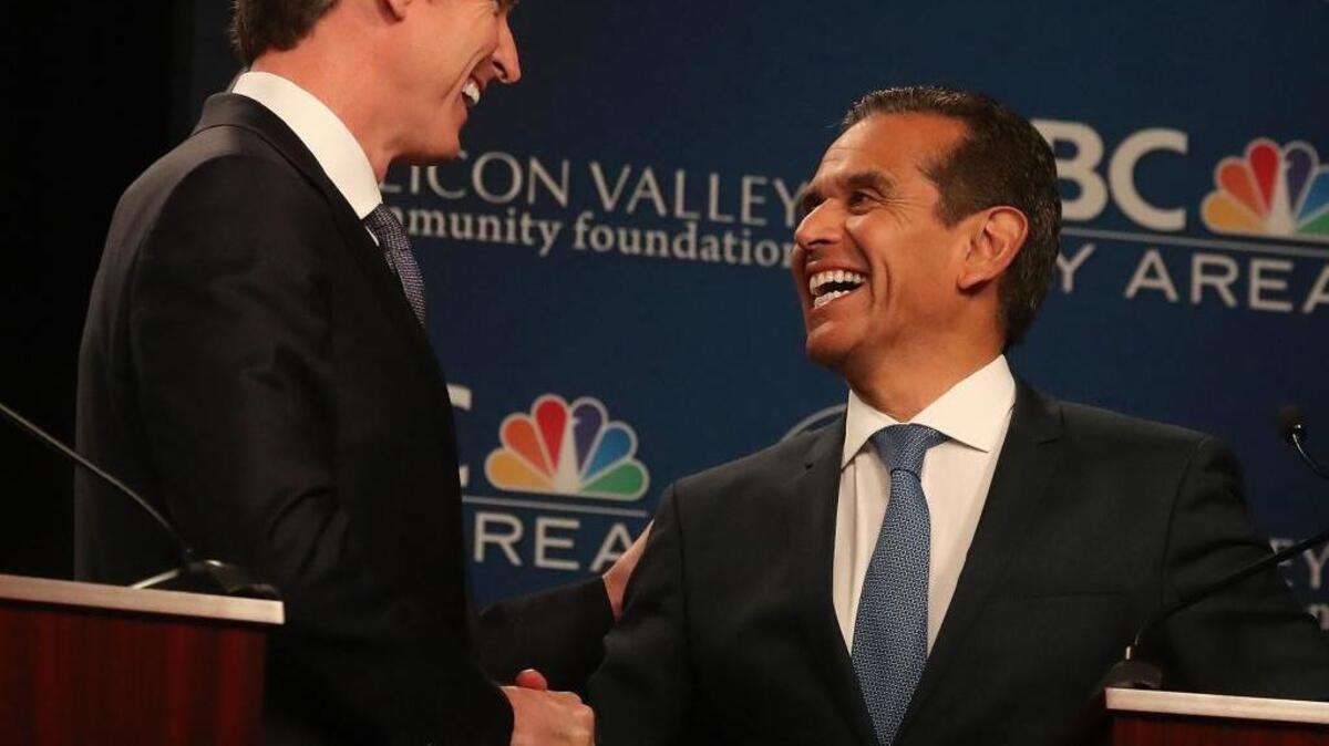 Democratic gubernatorial candidates Gavin Newsom, left, and Antonio Villaraigosa shake hands after a debate at the California Theatre, Tuesday, May 8, 2018, in San Jose, Calif. The former mayors have differing approaches to charter schools. (Aric Crabb/San Jose Mercury News-Bay Area News Group via AP)